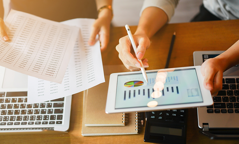 lose up group of businessman use stylus pen for explaining dashboard about company's profit monthly on tablet and businesswoman holding report paper for collaborate work at meeting event , business finance concept